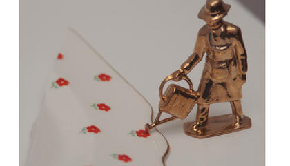 Liliana Porter The Gardener, 2015. Bronze figure, piece of porcelain on white wooden shelf.. 5 x 10,4 x 11,2 inches.